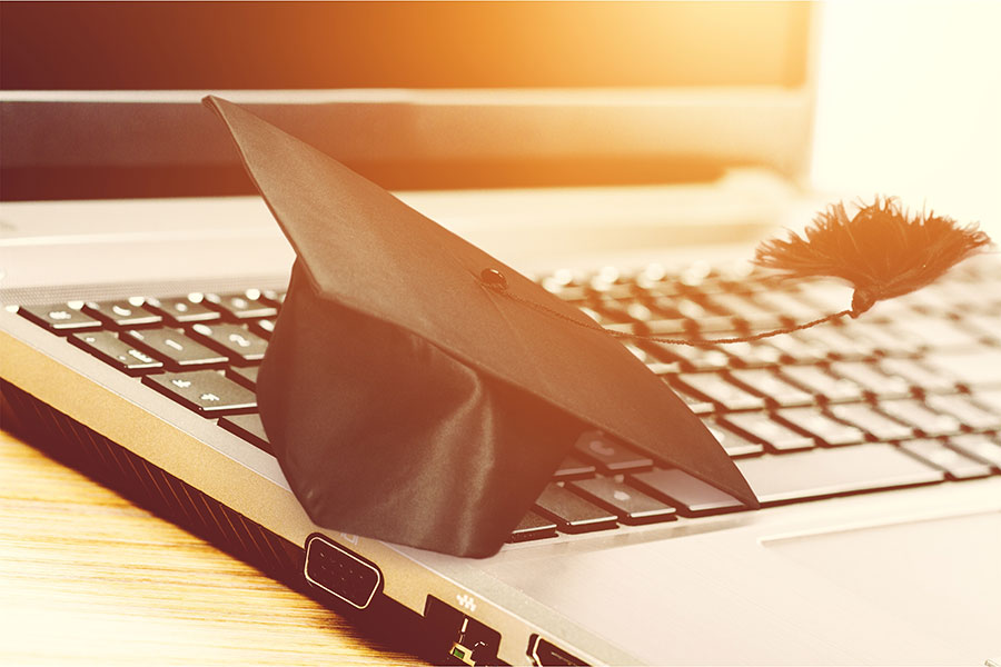 graduation cap on computer key board