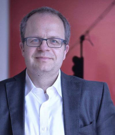 Man with glasses and dark blue suit