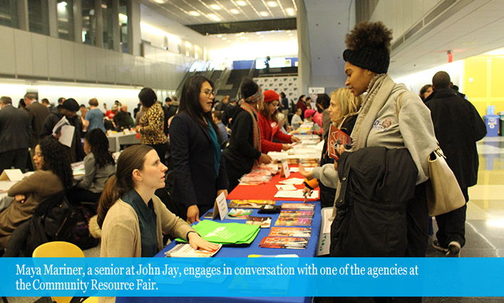 Maya Mariner, a senior at John Jay, engages in conversation with one of the agencies at the Community Resource Fair