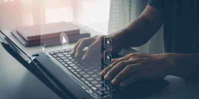 Image showing man using laptop to access Learning Management System Webinars