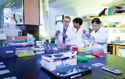 Faculty and students in a lab