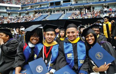 four students at commencement